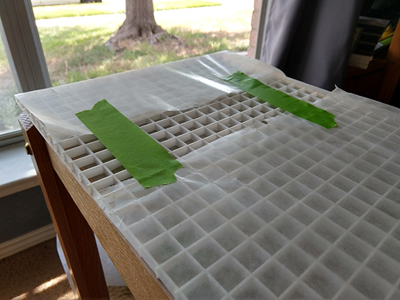 In subsequent pours these covers were set up on small dowels at the corners to keep the paper away from the epoxy surface.